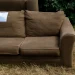 A view of an old couch placed outdoors with a “free” sign, illustrating how to get rid of a couch through curbside pickup, donation, or free giveaway as part of common furniture disposal options.