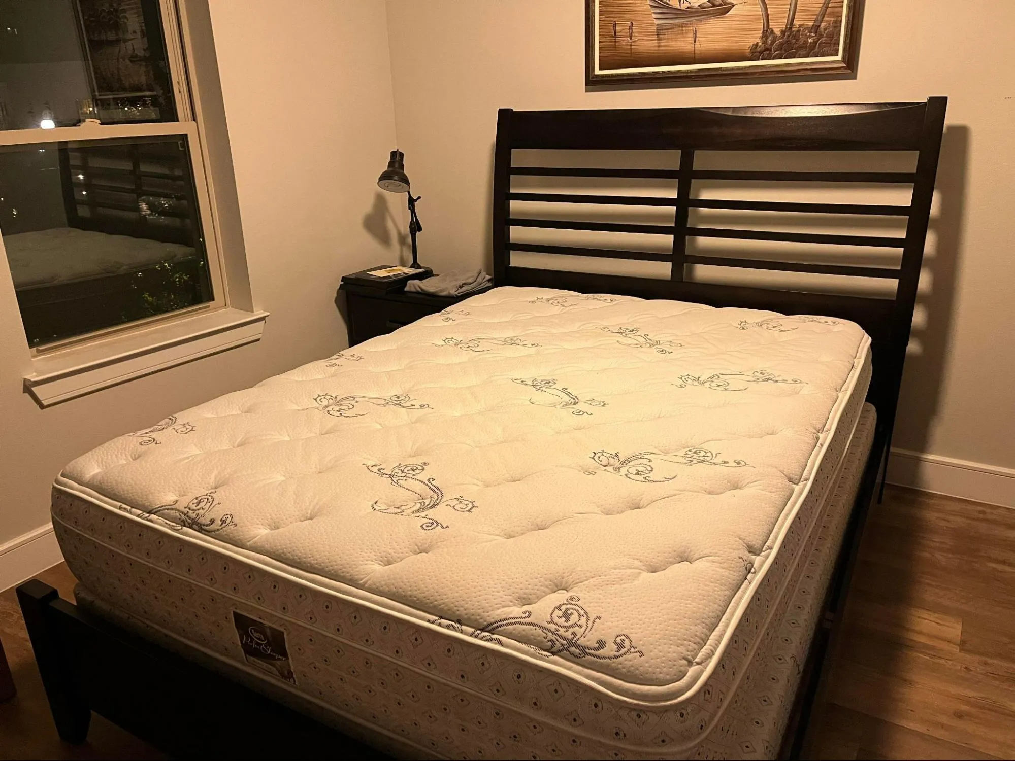 A mattress on a bed in a warm bedroom