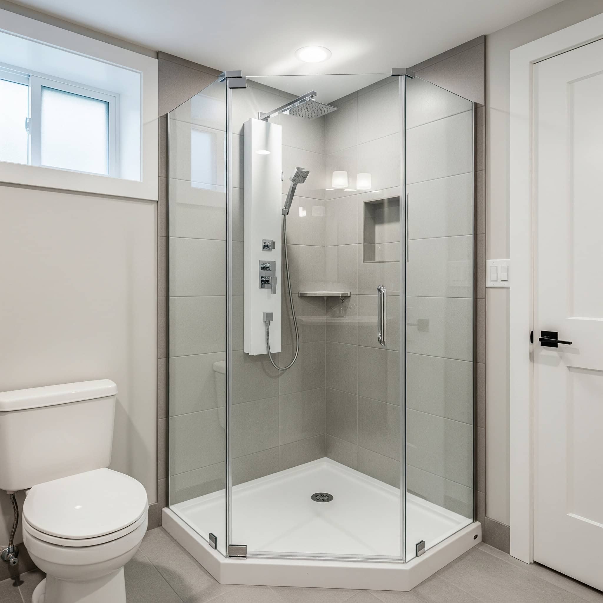 Corner shower installation in a basement bathroom.