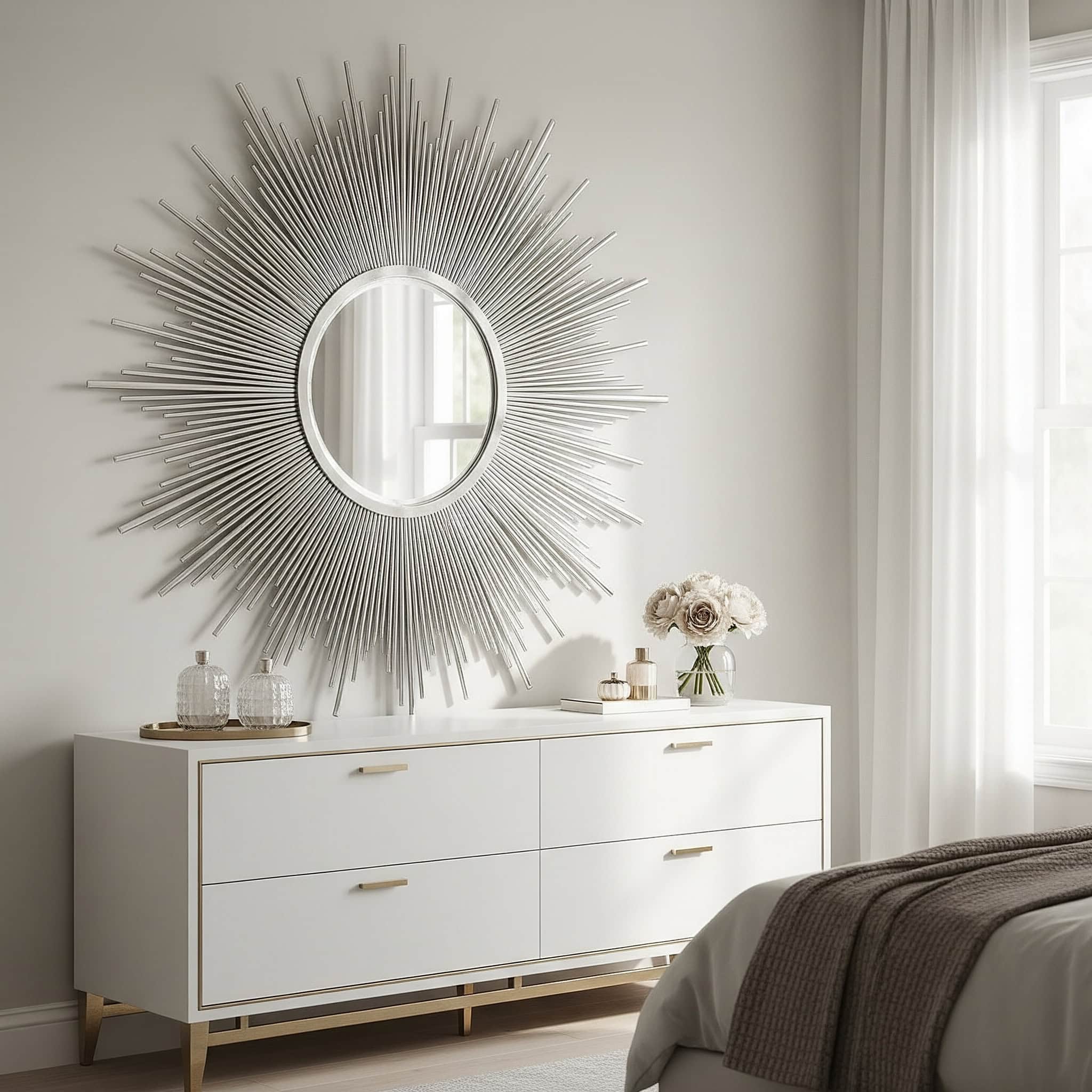 Bedroom with a sunburst mirror above a dresser