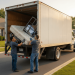 Professional movers loading an old mattress and bed frame into a Jiffy Junk truck on a residential street, illustrating the best old used bed and mattress pickup and disposal service with cheap prices near me; Jiffy Junk makes removal simple.