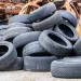 Large pile of used tires and rims at a scrap yard, representing cheap bulk tire and rim disposal services near me with fast, hassle-free junk hauling.