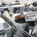 An image of old televisions, computers, and stereo equipment piled in recycling bins at an e-waste facility, illustrating proper electronics disposal and recycling methods