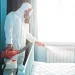 An image of a pest control technician in protective suit using a fogger to treat a bedroom for bed bugs, illustrating bed bug removal cost, exterminator services, and treatment pricing options
