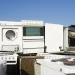 An image of old appliances including a washer, dryer, oven, and refrigerator stacked for removal, illustrating old appliance haul away and disposal services near me