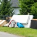 An image of curbside junk removal pile with furniture and household items, showing typical residential pickup and local junk removal costs near me