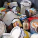 An image of old latex and oil paint cans piled together for safe disposal and proper removal of leftover household paint