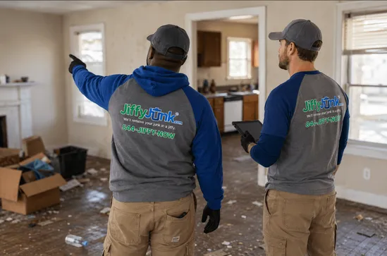 A Jiffy Junk team efficiently clears a vacant bank-owned home, loading remaining belongings into a Jiffy Junk truck while documenting progress with photos, illustrating the fast, fully documented REO and foreclosure cleanout services trusted by asset managers nationwide.