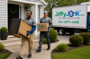 Two Jiffy Junk professionals carefully carry an old sofa and dresser from a residential living room toward a clean Jiffy Junk truck, demonstrating the care, professionalism, and White Glove Treatment behind full service furniture removal and disposal.