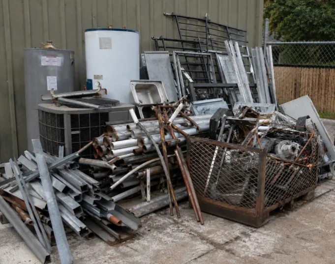 An image of scrap metal ready for pickup and recycling, featuring metal pipes, appliances, and industrial materials awaiting eco-friendly scrap metal removal and haul away services.