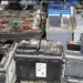 An image of used car batteries awaiting recycling, illustrating how to dispose of a car battery safely.