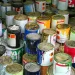 An image of old paint cans awaiting disposal, illustrating how to dispose of paint safely, including latex paint, oil-based paint, and spray paint.
