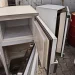 An image of old refrigerators awaiting recycling and disposal, showing how to dispose of a refrigerator in Grand Rapids through responsible appliance recycling or junk removal services.